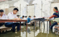 কক্ষে হাঁটু পানি, বেঞ্চে পা তুলে পরীক্ষা দিলো এসএসসি পরীক্ষার্থীরা
