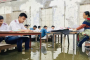 কক্ষে হাঁটু পানি, বেঞ্চে পা তুলে পরীক্ষা দিলো এসএসসি পরীক্ষার্থীরা